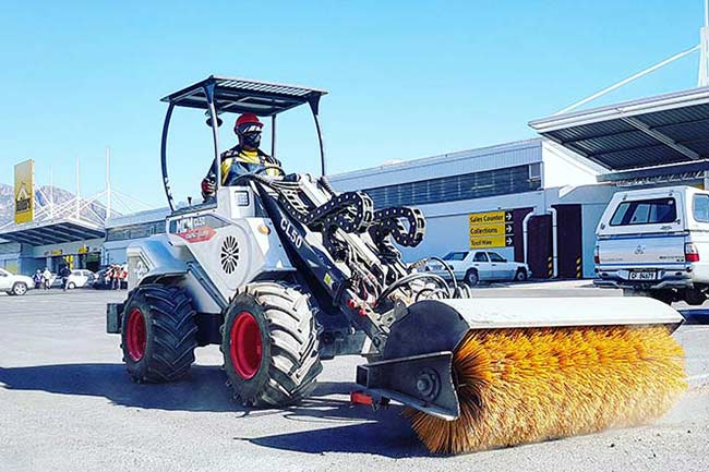 CL50 Compact Loader with Open Sweeper Attachment
